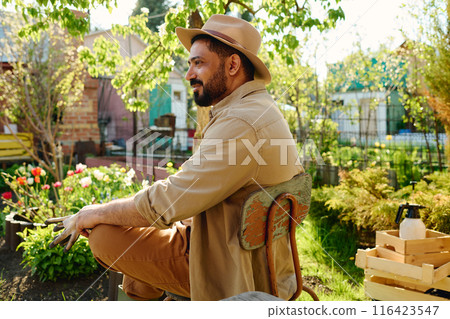 Serene mature man in hat and workwear Serene mature man in hat and workwear 116423547