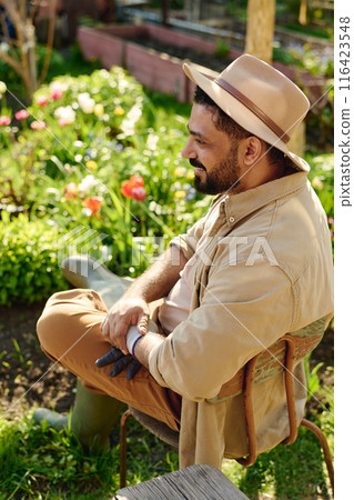 Farmer enjoying rest in the garden 116423548