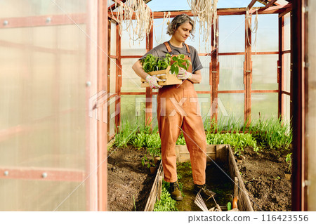Mature female farmer in overalls 116423556