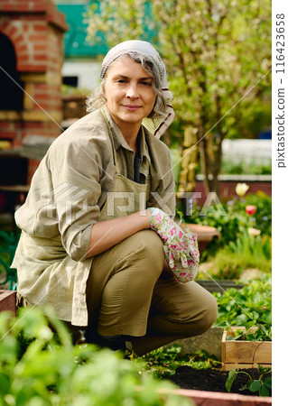 Portrait of pretty gardener in workwear Portrait of pretty gardener in workwear 116423658