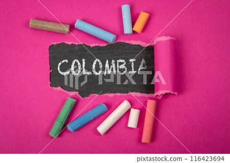 COLOMBIA. Word under torn purple paper on a blackboard 116423694