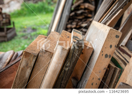 Remnants of old boards, timber waste and building materials 116423695