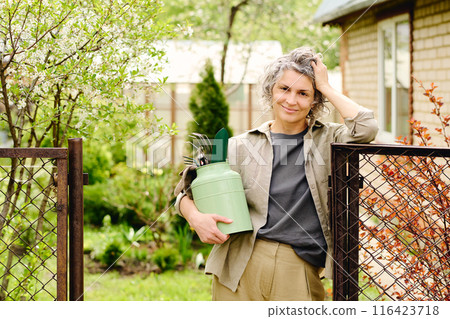 Happy female gardener with worktools Happy female gardener with worktools 116423718