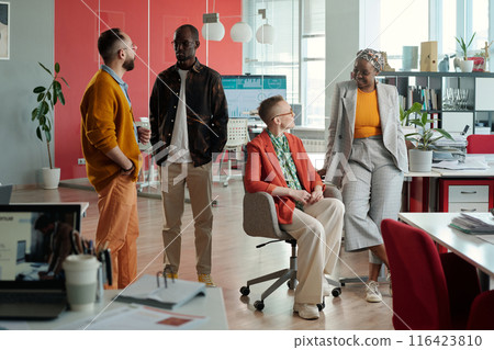 Diverse Colleagues Having Conversation in Modern Office 116423810