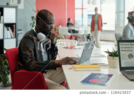 Black Man Working on Laptop in Modern Office 116423837