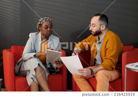 Colleagues Discussing Project Details on Tablet Colleagues Discussing Project Details on Tablet 116423919