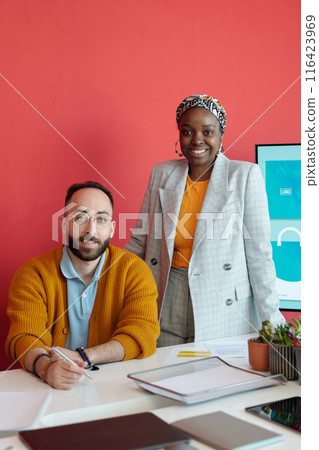 Colleagues Posing in Office with Red Wall Background Colleagues Posing in Office with Red Wall Background 116423969