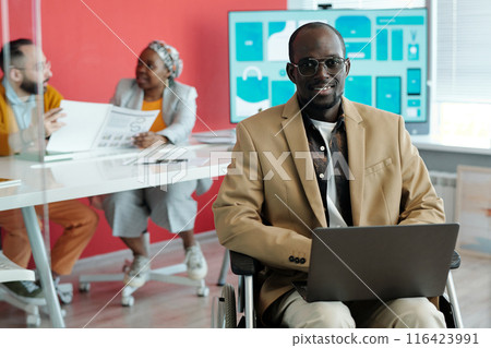 Portrait of Smiling Black Man in Wheelchair with Laptop 116423991