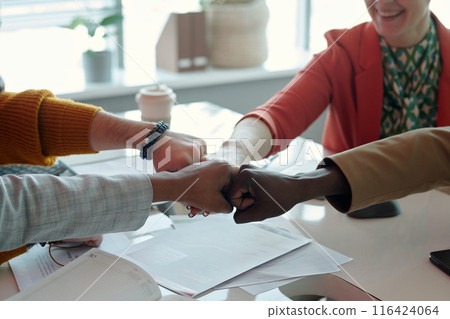 Team Fist Bump During Office Meeting Team Fist Bump During Office Meeting 116424064