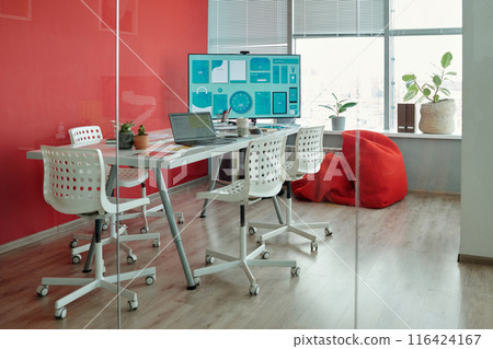 Modern Office Meeting Room With Red Wall and Large Screen 116424167