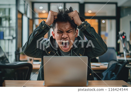 photo of a person raising both hands to tangle in his own hair. Expressing dissatisfaction, mouth wide open in an open office There was a laptop on the table in front of Category People photo of a person raising both hands to tangle in his own hair. Expressing dissatisfaction, mouth wide open in an open office There was a laptop on the table in front of Category People 116424544