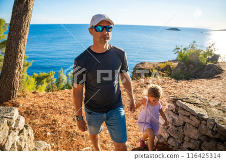 Father and daughter in shore in the bay of Uvala Gradina near the town of Vela Luka on the island of Korcula in Croatia Father and daughter in shore in the bay of Uvala Gradina near the town of Vela Luka on the island of Korcula in Croatia 116425314
