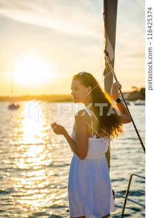 Young woman sailing, young adult lady enjoying summer travel, close-up portrait of female face, summer cruise holidays, European girl tourist traveling in sail boat in Croatia Young woman sailing, young adult lady enjoying summer travel, close-up portrait of female face, summer cruise holidays, European girl tourist traveling in sail boat in Croatia 116425374