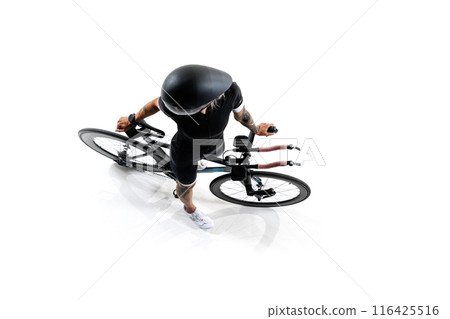 Woman, cyclist in black cycling gear and aerodynamic helmet holding modern racing bike isolated on white background. Woman, cyclist in black cycling gear and aerodynamic helmet holding modern racing bike isolated on white background. 116425516