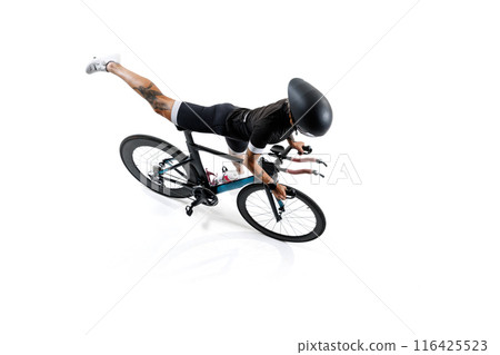 Female cyclist in professional gear and helmet sitting on road bike isolated on white background. Female cyclist in professional gear and helmet sitting on road bike isolated on white background. 116425523