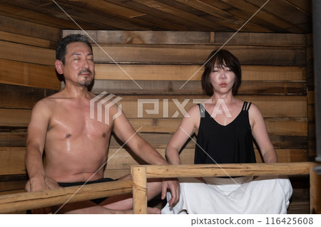 Senior couple relaxing together in the sauna Senior couple relaxing together in the sauna 116425608