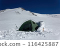 Lone tent pitched on snowy Mount Elbrus slope, surrounded by icy peaks. Green tent amid white snow, adventure travel, extreme camping at high altitude. 116425887