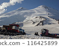 Snowcats parked on Elbrus Mountains, preparing slopes for skiers. Winter machines groom snow, ensure safe, smooth skiing surfaces. Outdoor ski resort maintenance. 116425899