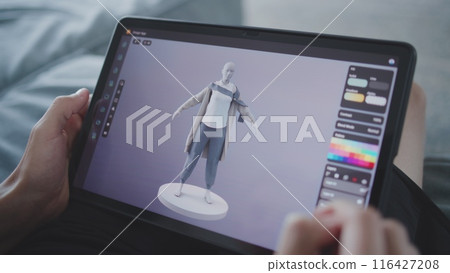 Teenager draws clothes using 3d modeling program 116427208