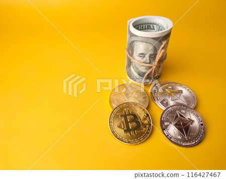 Banknotes with silver ethereum and golden bitcoin digital crypto coin on yellow background with copy space. Banknotes with silver ethereum and golden bitcoin digital crypto coin on yellow background with copy space. 116427467