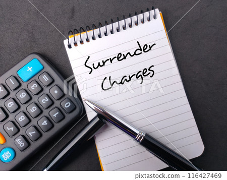 Top view calculator,pen and notebook with text Surrender Charges on black background. 116427469