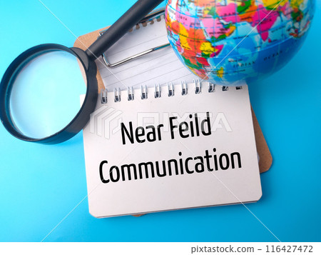 World globe,magnifying glass and notebook with text Near Feild Communication on blue background. 116427472