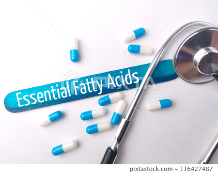 Stethoscope and pill capsule with text Essentail Fatty Acids on white background. 116427487