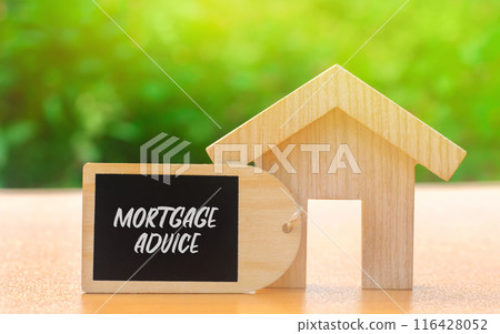 Mortgage advice concept. Professional guidance provided to help individuals choose, obtain, and manage home loans. Real estate. Wooden house with a note Mortgage advice concept. Professional guidance provided to help individuals choose, obtain, and manage home loans. Real estate. Wooden house with a note 116428052