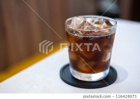 A glass of Cola on the table with blurred background A glass of Cola on the table with blurred background 116428073