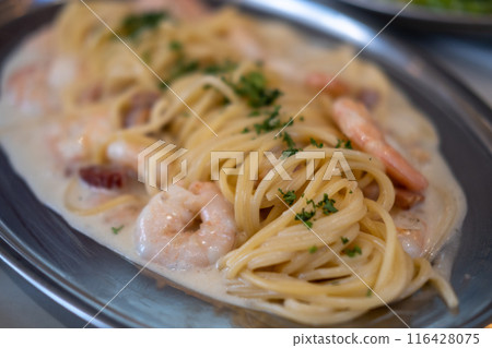 White wine cream sauce prawn and bacon pasta spaghetti served on plate White wine cream sauce prawn and bacon pasta spaghetti served on plate 116428075