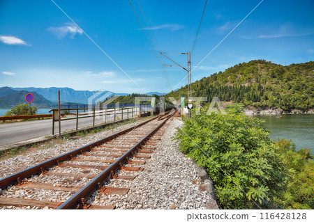 Captivating view of Skadar lake surrounded by green mountain peaks on a sunny day. Captivating view of Skadar lake surrounded by green mountain peaks on a sunny day. 116428128