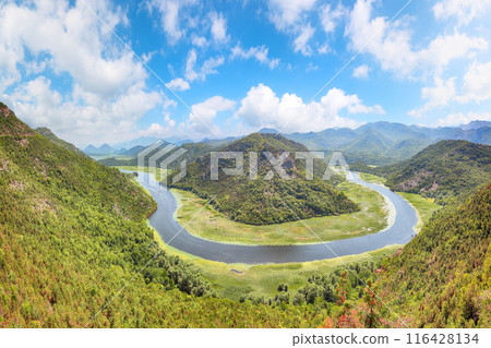 Captivating view of the Crnojevic river bend around green mountain peaks on a sunny day. 116428134