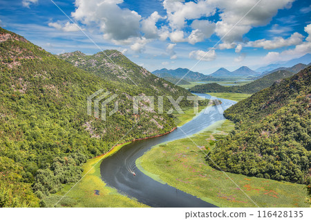Captivating view of the Crnojevic river bend around green mountain peaks on a sunny day. Captivating view of the Crnojevic river bend around green mountain peaks on a sunny day. 116428135