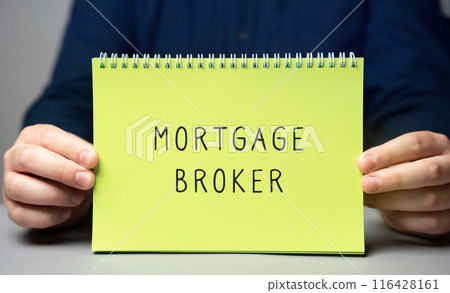 Mortgage broker concept. A licensed intermediary who connects borrowers with lenders by offering expert advice and assistance tailored to the borrower's financial needs. Note in male hands 116428161