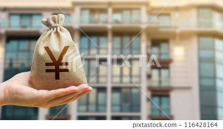 Chinese yuan or japanese yen bag against the background of modern high-rise buildings. Investing in the purchase of real estate. Affordable housing and mortgage rates. Renting apartments and houses 116428164