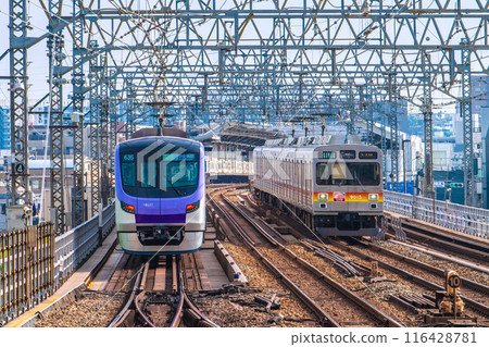 Kawasaki cityscape in Japan in July. View of Futako-Shinchi Station, Tokyo Metro trains, and Oimachi local trains from the Futako Tamagawa side. 116428781
