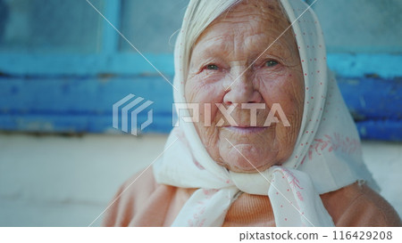 Portrait of an elderly woman. Looks at the camera 116429208