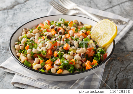 Salad of Mavromatika of Feneos made with black-eyed peas and vegetables closeup on the plate. Horizontal Salad of Mavromatika of Feneos made with black-eyed peas and vegetables closeup on the plate. Horizontal 116429358