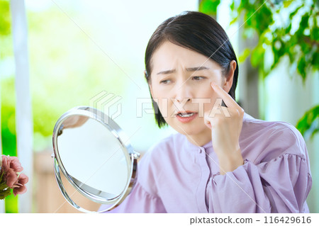 Middle woman worried about fine wrinkles 116429616