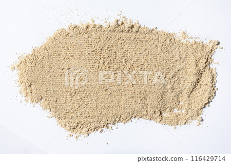 Smear of ground ginger, dry ginger root powder on white background. 116429714