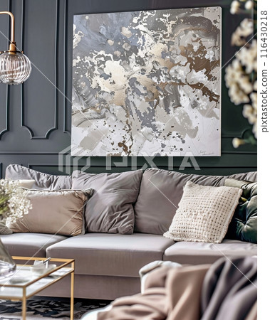 Sophisticated living room featuring a stunning abstract canvas painting with luxurious gold and silver textures, elevating the interior design 116430218