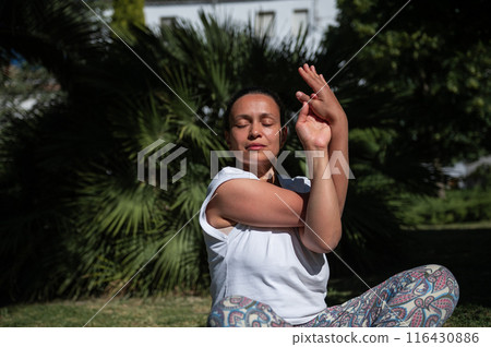 Woman practicing yoga in nature, serene outdoor meditation session Woman practicing yoga in nature, serene outdoor meditation session 116430886