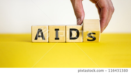 Symbol for helping people with aids, Acquired immunodeficiency syndrome. Doctor turns a wooden cube with words aids aid. Beautiful white, yellow background, copy space. Medical and aids aid concept. Symbol for helping people with aids, Acquired immunodeficiency syndrome. Doctor turns a wooden cube with words aids aid. Beautiful white, yellow background, copy space. Medical and aids aid concept. 116431380