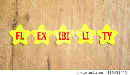 Flexibility symbol. Concept word Flexibility on beautiful yellow paper stars. Beautiful wooden background. Business flexibility concept. Copy space. Flexibility symbol. Concept word Flexibility on beautiful yellow paper stars. Beautiful wooden background. Business flexibility concept. Copy space. 116431433