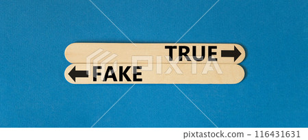 True or fake symbol. Concept word True or Fake on beautiful wooden stick. Beautiful blue table blue background. Business and true or fake concept. Copy space. 116431631