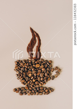 Coffee beans and grounds are arranged in the form of a steaming cup of coffee on a light background 116432383
