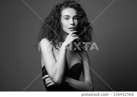 beautiful young woman with curly hair. black and white portrait 116432568