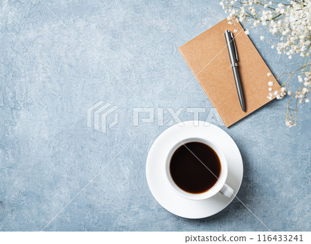 spring bouquet with white gypsophila flowers over a cup of black coffee and craft notepad spring bouquet with white gypsophila flowers over a cup of black coffee and craft notepad 116433241