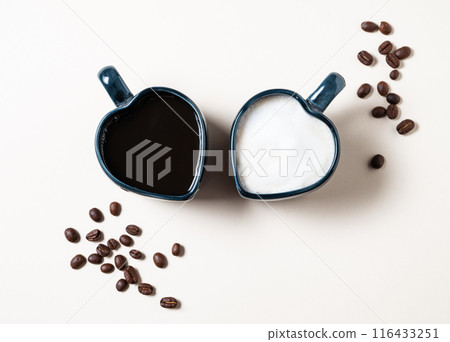 Two cups in the form of hearts with freshly brewed aromatic coffee with milk and espresso Two cups in the form of hearts with freshly brewed aromatic coffee with milk and espresso 116433251