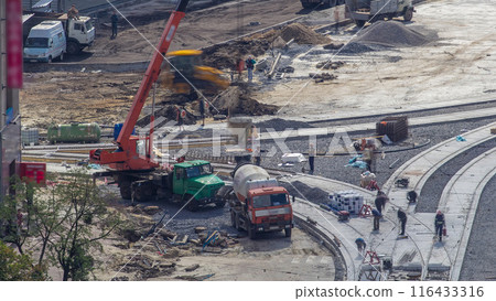 Concrete works for road construction with many workers and mixer timelapse 116433316